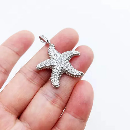polished silver starfish pendant flat lay