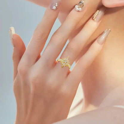 Close up of gold star moissanite ring