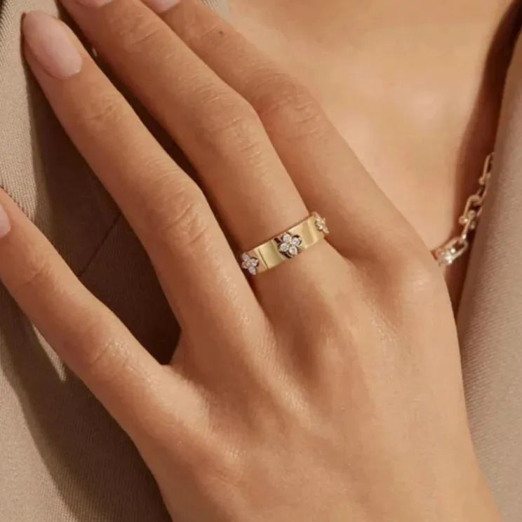 gold moissanite ring worn on model hand