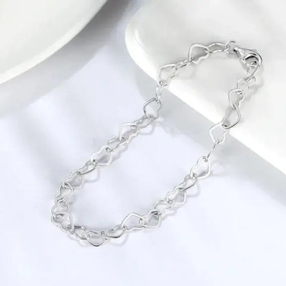 silver heart bracelet styled on wrist — everyday elegance