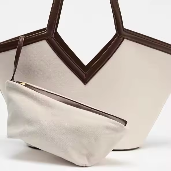 elegant women’s tote bag with drawstring closure and appliqué details