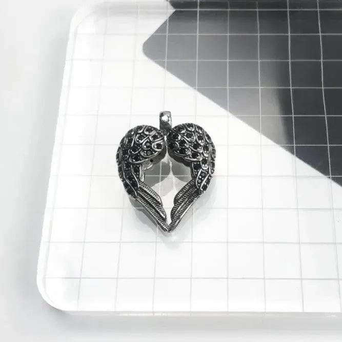 handcrafted silver pendant with angel wings and heart shape