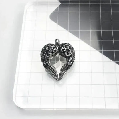 handcrafted silver pendant with angel wings and heart shape