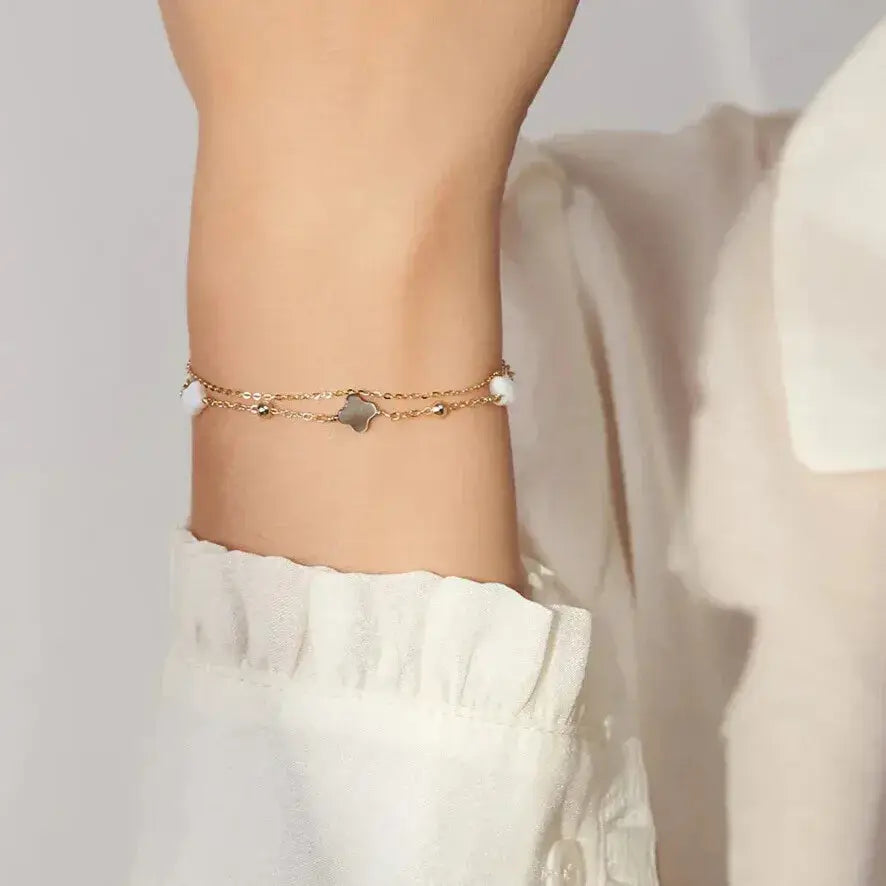 woman wearing gold four-leaf clover bracelet