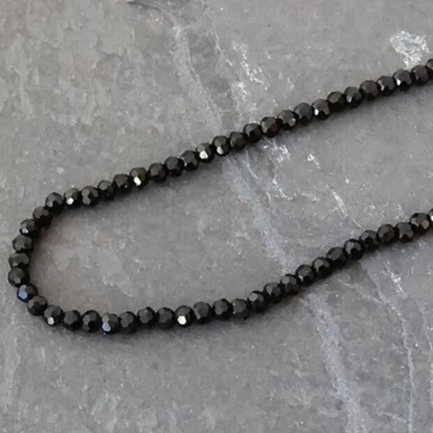 Evening outfit styled with black crystal heart pendant