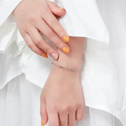 high-polish silver bracelet with delicate heart motifs