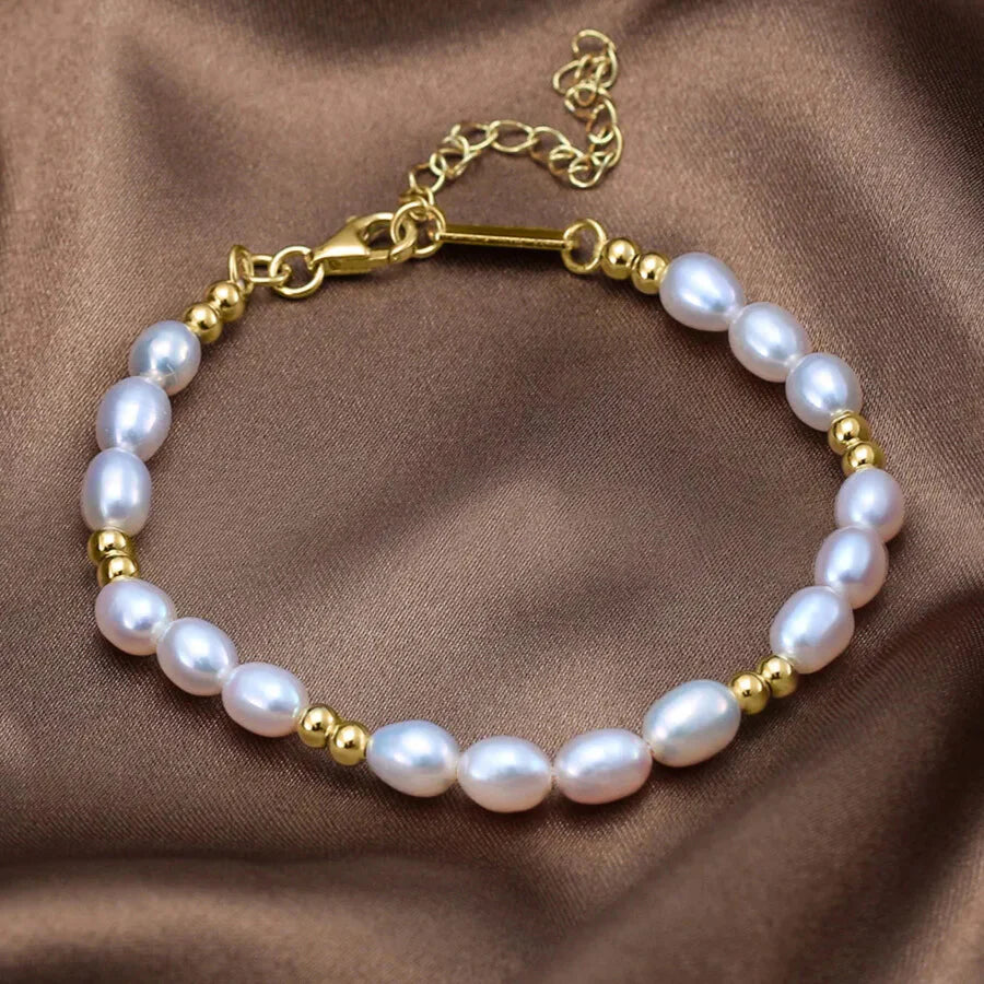 Elegant pearl bracelet with gold beads on wrist