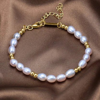 Elegant pearl bracelet with gold beads on wrist