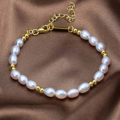 minimalist pearl and gold bracelet against neutral background